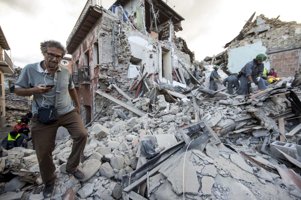 Rescuers on the rubble in Amatrice, central Italy, where a 6.1 earthquake struck just after 3:30 a.m., Wednesday, Aug. 24, 2016. The quake was felt across a broad section of central Italy, including the capital Rome where people in homes in the historic center felt a long swaying followed by aftershocks. ANSA/ MASSIMO PERCOSSI
